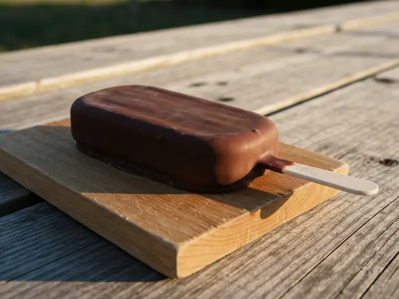 A single ice cream bar with a thick chocolate coating