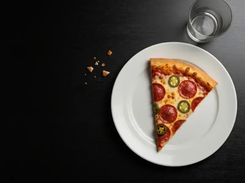 A single slice of Pizza Hut Thin 'N Crispy Veggie Lover's pizza