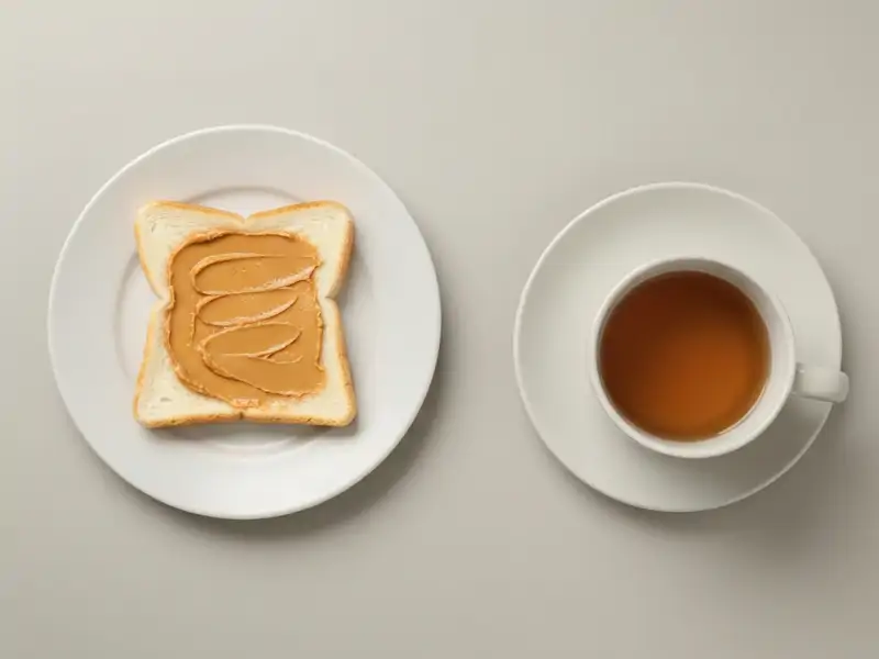 A piece of plain white toast with a thin spread of peanut butter